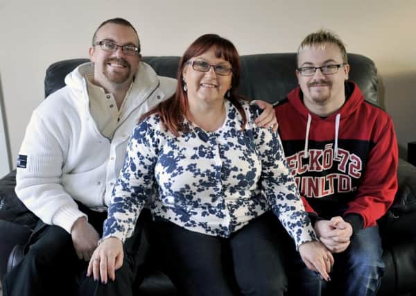 Janet Williams with her sons, left, Lee Williams and right, Philip Williams