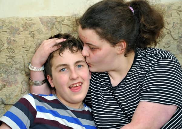 Young carer Hazel  with her brother Matthew, 15, who she helps take care of