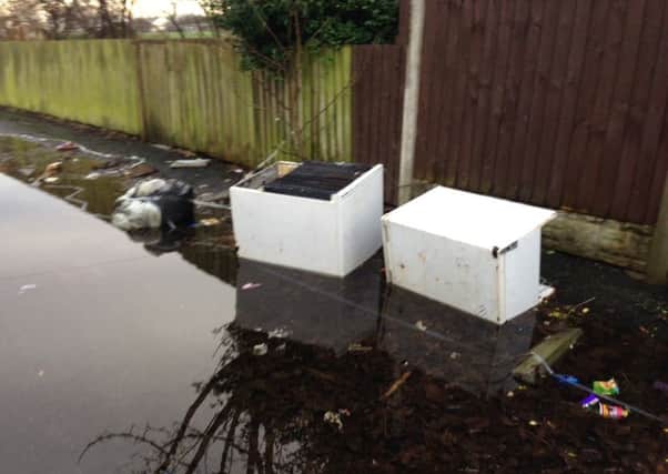 Flytippers have dumped two fridges in the alleyway  the latest of many such incidents, according to residents