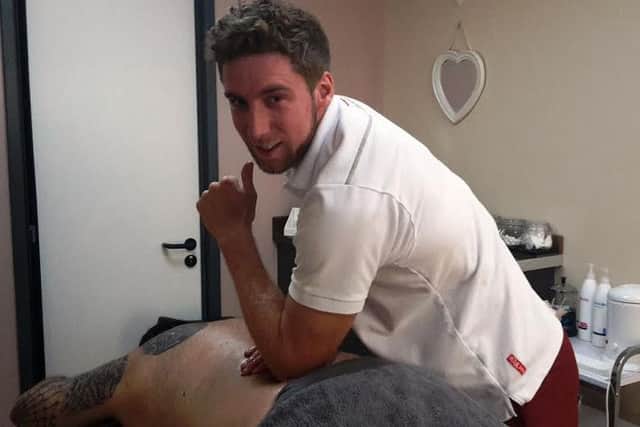 Pole vaulter Max Eaves in his day job as a sports massage expert.
