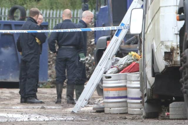 Police remain at the scene of Pendle Skip Hire last summer