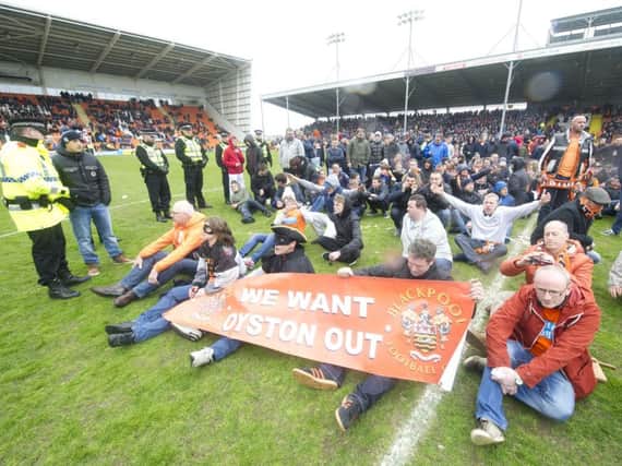 Blackpool fans stage a protest and pitch invasion against the running of the club by the Oyston family