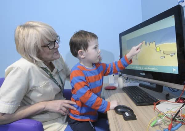 Brian House have been donated new equipment for children to play with.  Pictured is nurse Janet Miller with Owen Probert, aged 3.