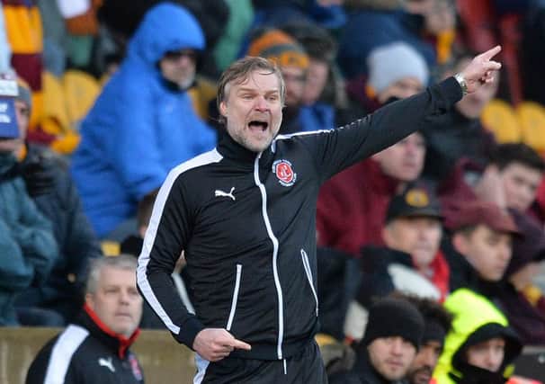 Fleetwood Town's Manager Steven Pressley shouts instructions to his team from the dug-out