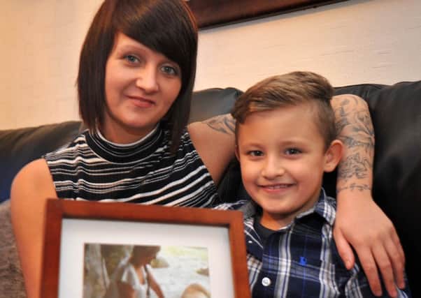 Gemma Field, of Preston Old Road in Marton, will be skydiving for the Macmillan Cancer charity in March in memory of her son Jamie's great-nanna Linda Harris.
Gemma and Jamie with a photo of Linda.  PIC BY ROB LOCK
30-1-2016