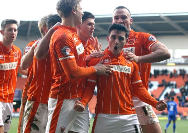 Blackpool's Jack Redshaw is mobbed by team-mates as he celebrates Pool's winner from the penalty spot
