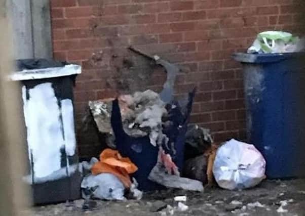 Police are called to a back lane in Monkton Avenue after a bin exploded.