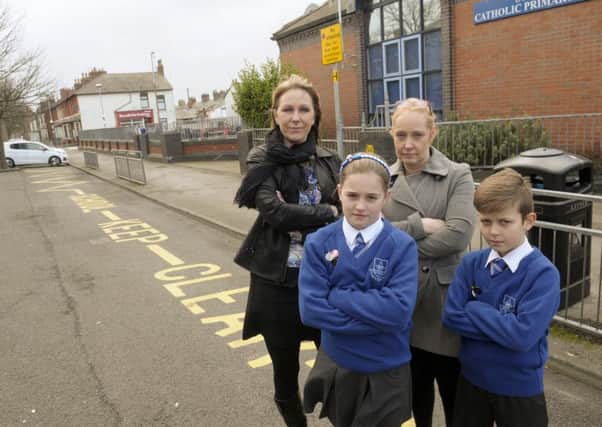 St Mary's Primary School pupils and staff are concerned with parents parking outside the school. Pictured are Harrison McLeod and Katie Ramsbottom with headteacher Ann Kowalska and bursar Karen Tew.