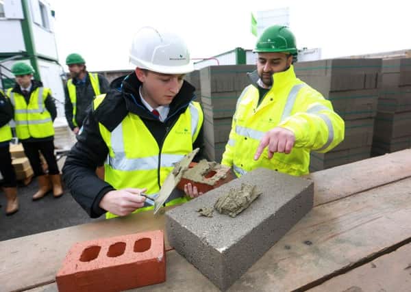 McCarthy & Stone Orchid Court, Lytham St Annes  McCarthy & Stone Assistant Site Manager Sadeem Khan teaching Red Rose School pupil Nathan Burgess the art of bricklaying.   Photo credit:  leeboswellphotography.com