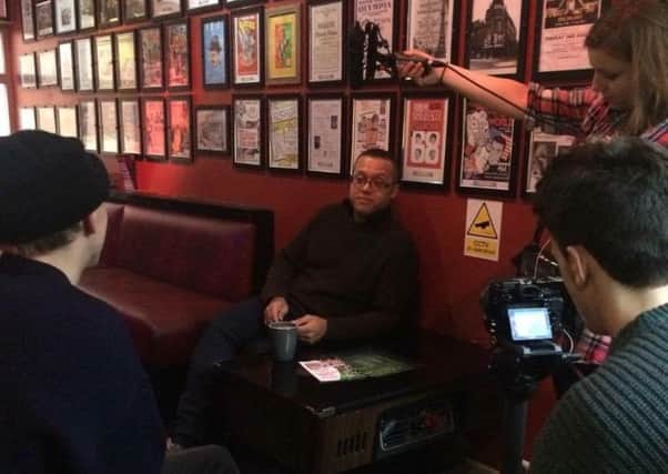Stephen Pierre, owner of the Galleon Bar, chats to Bournemouth University media students