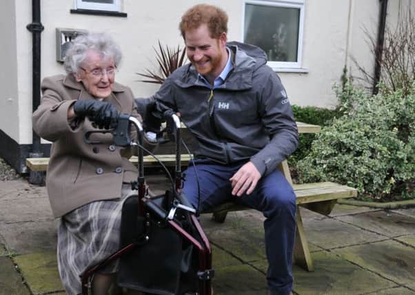 Prince Harry in St Michaels during a visit to meet local flood victims, with 97 year old Winifred Hodson