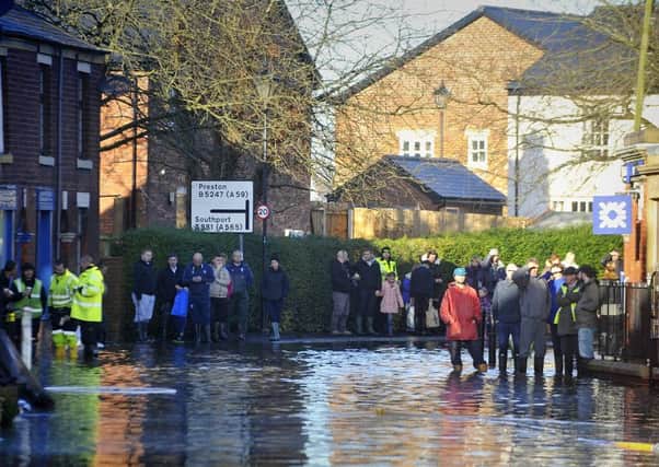 The Lancashire village of Croston was one of the worst affected in the area by the Boxing Day floods.
Residents gather to watch pumping operations begin.  PIC BY ROB LOCK
27-12-2015