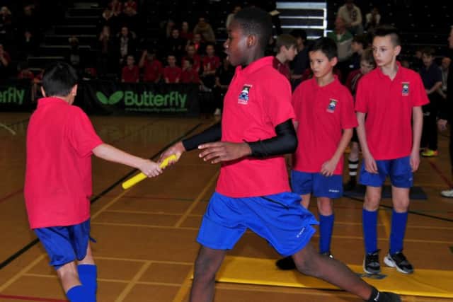 Blackpool Secondary Schools Indoor Athletics Finals held in Blackpool Sports Centre. 
St Mary's Academy's Sheick Fadairo hands over the baton