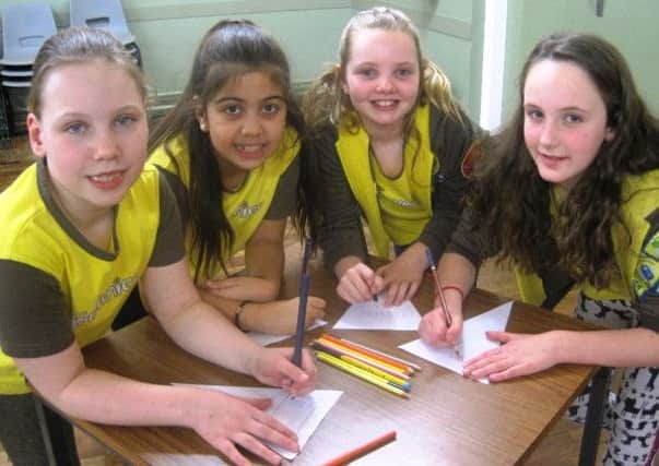 Busy designing flags for Lytham Flag Festival - Brownies Lily Smith, Lucy Dulay, Robyn Fairhurst and Maisie Eammes