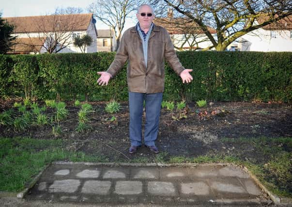 Les Fletcher, chairman of the Friends of the Memorial Park in Fleetwood, shows the empty spot where a damaged bench had to be removed