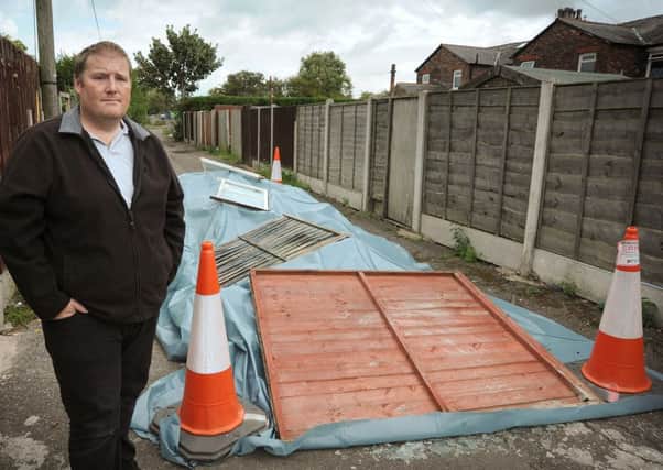 David Gregson, of Gamble Road in Thornton, is fed up of fly-tippers leaving piles of rubbish in the alleyway behind his house.
David with the latest arrival, which he thinks may contain asbestos and has been covered by Wyre Council.  PIC BY ROB LOCK
13-8-2014