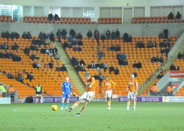 Blackpool's Brad Potts takes a shot but look at the empty seats behind him