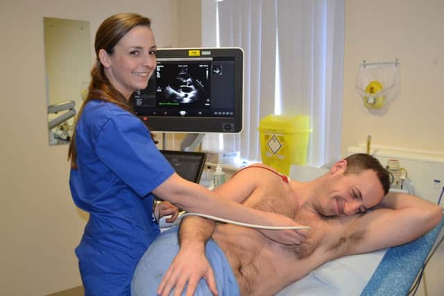 Cardiac physiologist Carly Pomfret checks the heart of Ian Morton