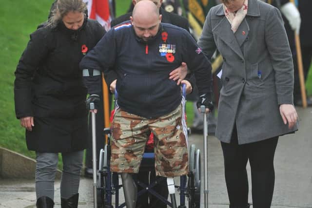 Rick Clement takes his first  public steps at the war memorial
