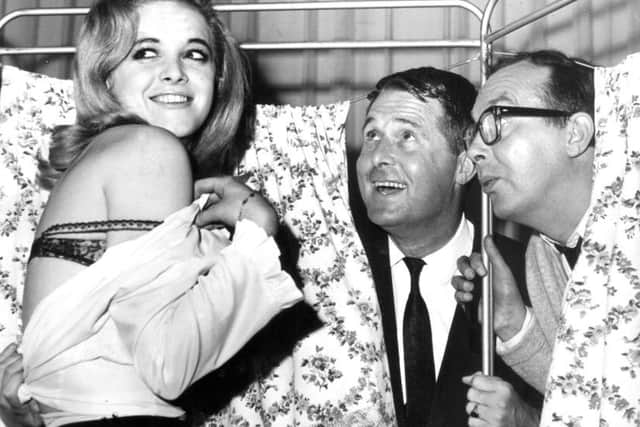 Eric and Ernie get a surprise when they peep through a screen during a photocall for the Morecambe and Wise Show, at the ABC Theatre Blackpool, in 1965. Also surprised is 20 year old Valerie Barrett of Blackpool
seaside stars