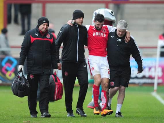 Conor McLaughlin is helped off the pitch