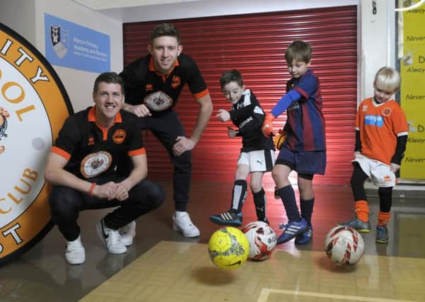 Blackpool players Jim McAlister and Will Aimson visit children during a half-term sports skills event hosted by the Community Trust