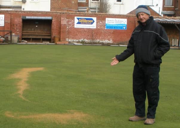Dave Walters, honorary secretary of Strawberry Gardens Bowling Club, with damage on the green.