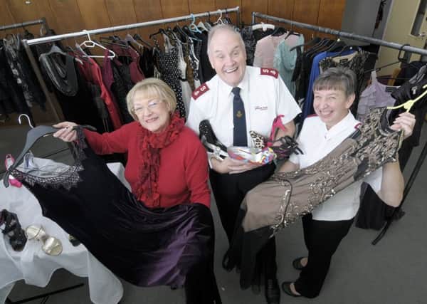 the Salvation Army are giving prom dresses to those most in need.  Pictured is volunteer Wyn Allen with majors Paul and Sandra Fisher.