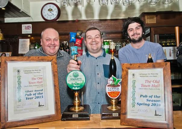 CAMRA Branch Chairman Paul Smith (L) presenting the awards to the Old Town Hall's assistant manager Simon Billington (c) and his barman brother Adam (R).