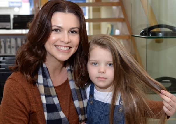 5 year old Sophie Beech  having her hair cut short for the Little Princess Trust. She's already raised Â£800.
Sophie is pictured with her mum, Caroline.