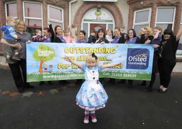 Treetops Nursery have been awarded outstanding by Ofsted.  Staff and children celebrate with Isabella Morrall, 4, in front.