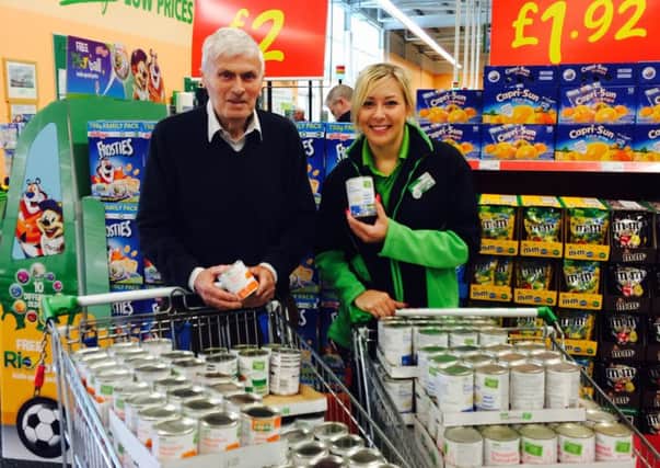 Layla Hampton and Ken Hayton from Fleetwood Food Bank, with two trolley loads of donated food.