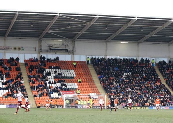 Empty seats among the Blackpool home supporters contrast with a near full Bradford City away end