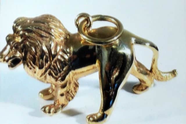 The family heirloom in the shape of a solid gold lion.