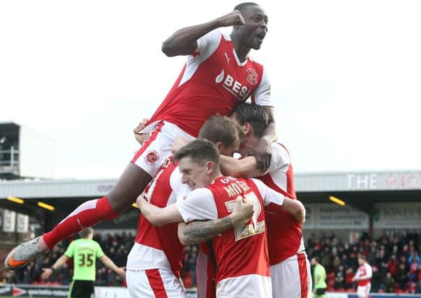 Fleetwood Town's Marcus Nilsson is mobbed by team-mates as he celebrates scoring his sides second goal with a flicked-on headerPhotographer Rich Linley/CameraSportFootball