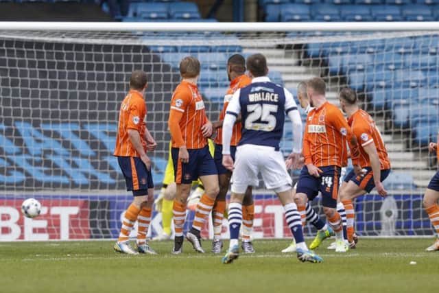 Jed Wallace's free-kick goes right through Blackpool's wall after John Herron (14) appeared to turn his back