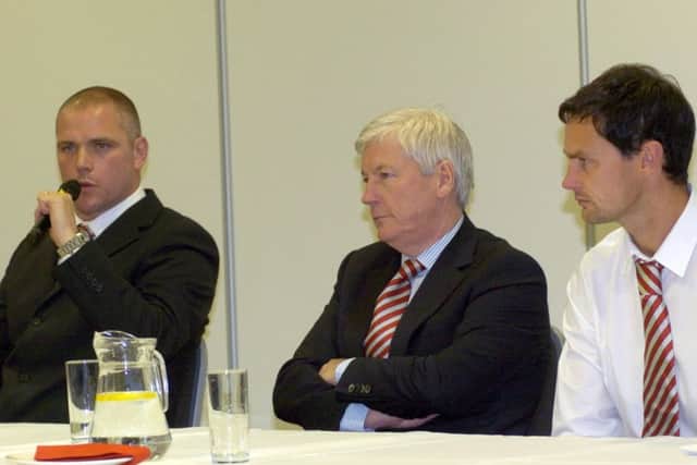 Morecambe manager Jim Bentley , chairman Peter McGuigan and head of youth Stewart Drummond.