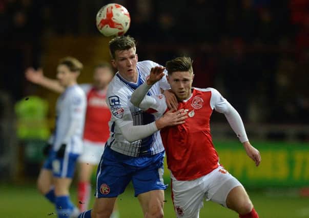 Fleetwood Town's Wes Burns battles with Walsall's Paul Downing  Photographer Dave Howarth/CameraSport