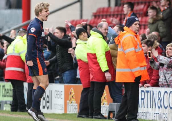 Blackpool's Brad Potts celebrates with fans at full time
