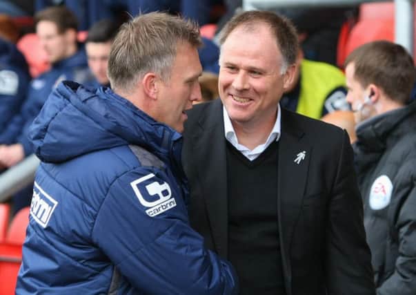Blackpool manager Neil McDonald shakes hands with Crewe Alexandra boss Steve Davis