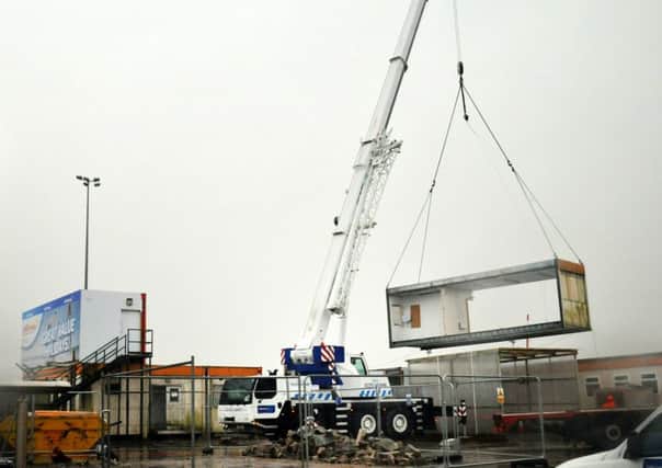 Work continues at Blackpool Airport with the arrival of a crane  NB. Pix taken in torrential driving rain!