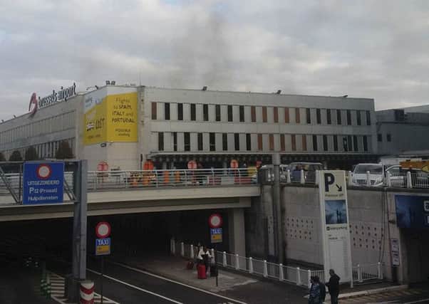 In this image provided by Daniela Schwarzer, smoke is seen at Brussels airport in Brussels, Belgium, after explosions were heard Tuesday, March 22, 2016. (Daniela Schwarzer via AP)
