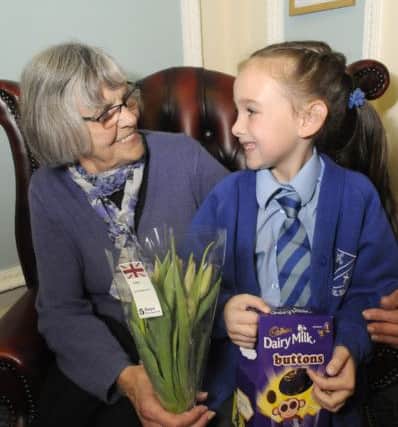 Pupils from Staining Primary school give Easter eggs and flowers to members of Just Good Friends in St Annes.  Pictured is Summer Roney, aged 6 with Margaret Stevens.
