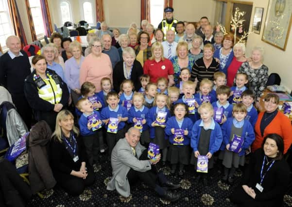 Pupils from Staining Primary school give Easter eggs and flowers to members of Just Good Friends in St Annes.