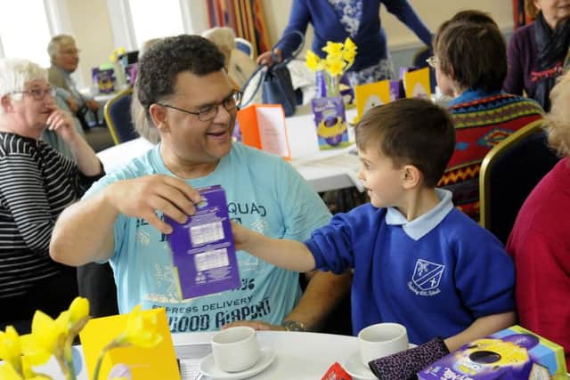 Pupils from Staining Primary school give Easter eggs and flowers to members of Just Good Friends in St Annes.  Richard Peters gets an egg from Finley Rodda, aged 5.