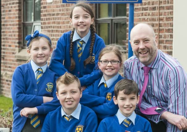 Staff and pupils from St Nicholas Primary School celebrate after being rated outstanding by Ofsted.  Pictured are Amelia Mottershead, Megan Dunkley, Emelia Carlton., Joe Hartenfeld and Owen McConnell with headteacher Andy Mellor.