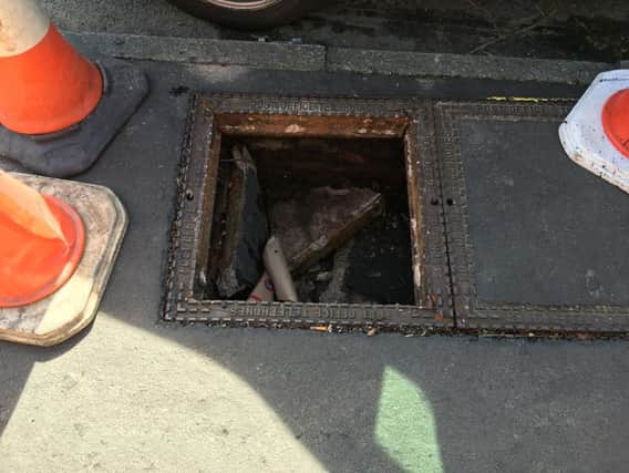 The damaged manhole cover
