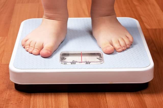 Stock image of a child on a scale