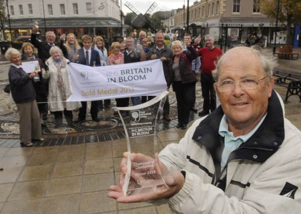Lytham In Bloom chairman Jim Leak with the RHS Champion of Champions award 2013, watched by fellow committee members