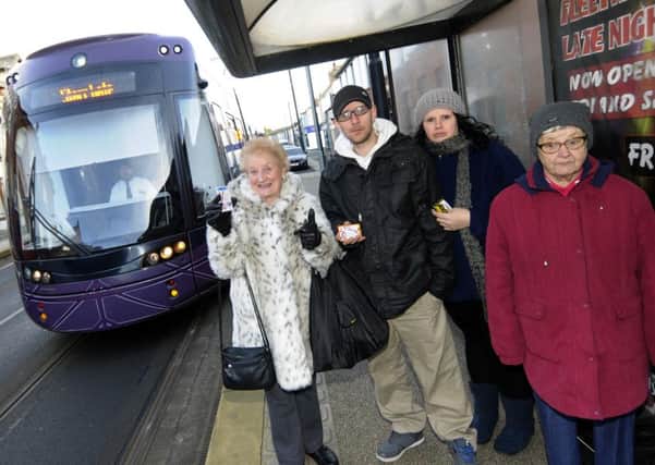 Service users at the Fleetwood tram stop outside the library